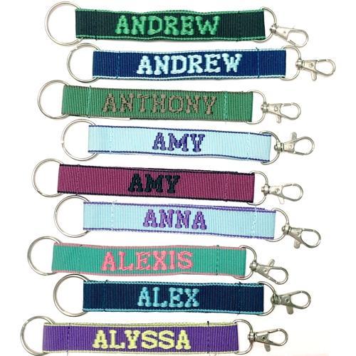 Wholesale Bundle of 100 - Embroidered Novelty Keychains - Nylon Key Strap & Clip (1" x 7.75") Assorted Names & Phrases